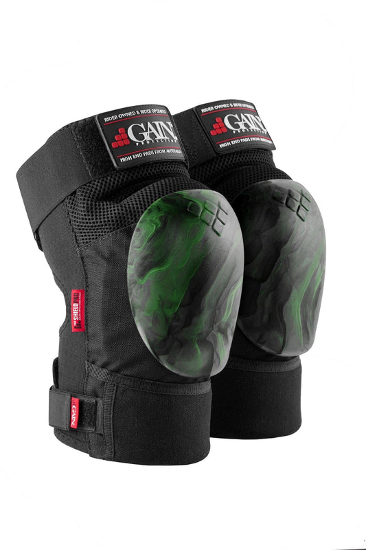 Introducing the GAIN Protection The Shield Pro Knee Skate Pads - Green Swirl, designed with black padding and green, marbled hard shell caps. Ideal for freestyle scootering or construction, these knee pads feature adjustable straps and prominent branding on top to ensure both style and maximum protection during any activity.