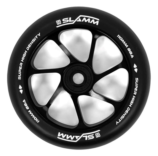 Close-up of a black scooter wheel with a white five-spoke design, made from high-rebound PU for enhanced durability. The tire is imprinted with "Slamm" and "Super High Density 110mm BBA," highlighting the premium-grade aluminum core of the Slamm Team 110mm Stunt Scooter Wheel - Black.