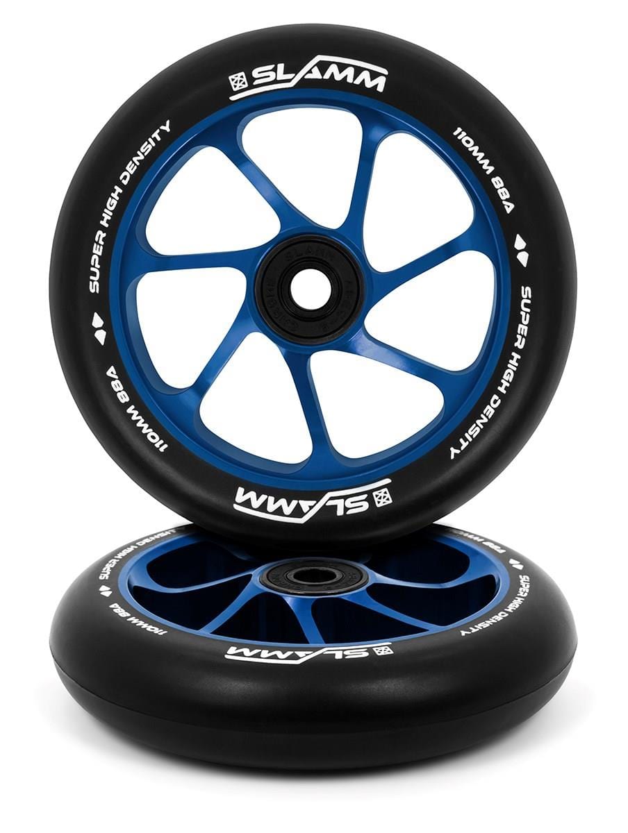 The Slamm Team 110mm Stunt Scooter Wheels by Slamm come in black and blue, featuring a white "SLAMM" logo and are marked with "Super High Density, 110mm, 88A." These wheels sport an aluminium core with a spoked design, displayed stacked with one standing upright and the other laid on its side.