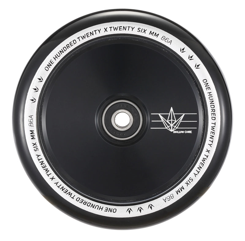 A detailed view of a black scooter wheel with a silver core highlights the Blunt Envy 120mm Hollow Core Stunt Scooter Wheel. The rim is inscribed with "ONE HUNDRED TWENTY X TWENTY SIX MM 86A" in white text, while the core displays a small logo featuring angular lines.