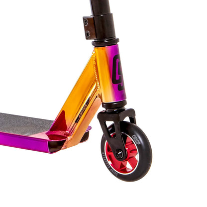 Close-up of the Crisp Switch 2020 Complete Stunt Scooter, showcasing its glossy chrome finish transitioning from purple to orange. It features robust chromoly steel bars, a black handlebar, and a small front wheel with red spokes and a black tire, highlighting its modern design and aluminum deck.