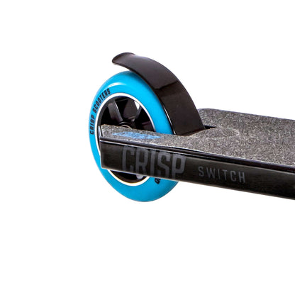 Close-up of the rear wheel of a Crisp Switch 2020 Complete Stunt Scooter, featuring a black aluminum deck. The striking blue wheel with black spokes catches the eye, and "Crisp" and "Switch" are prominently displayed on the side.