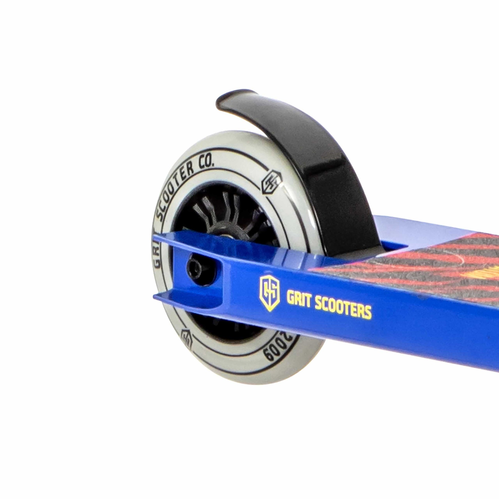 Close-up of the Grit Atom 2021 Kids Complete Stunt Scooter in Blue, highlighting its rear wheel. The branding from "Grit" and "Grit Scooter Co." is prominently displayed on the wheel, partially covered by a black fender. The deck showcases a vibrant design. This lightweight beginner stunt scooter is perfect for easy tricks.