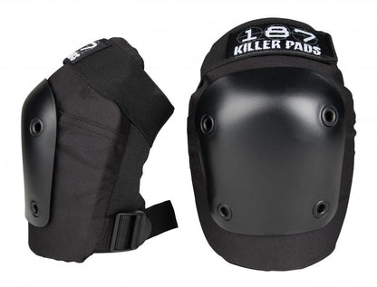 Two black knee pads with hard protective surfaces are shown, ideal for skaters seeking safety protection. The brand name "187" is visible on top. One pad faces forward while the other displays its adjustable strap from the side.