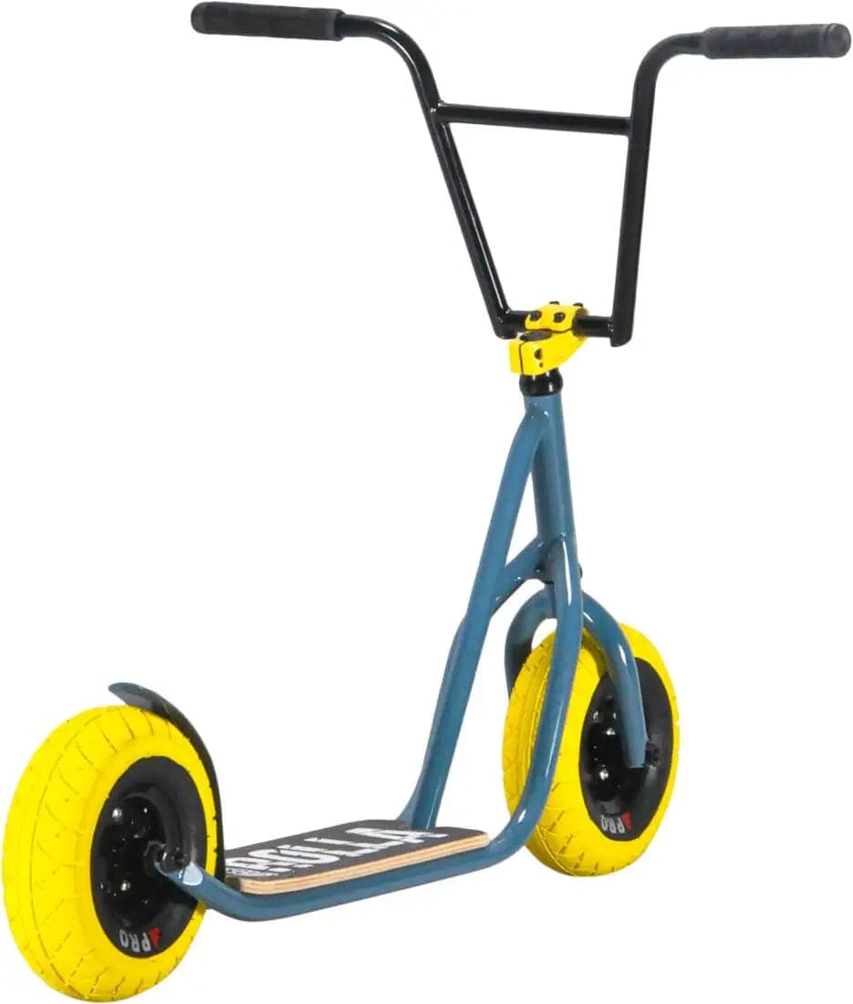 Check out the Rocker Rolla Big Wheel Complete Scooter by Rocker, featuring a striking grey design combined with blue and yellow accents. This kick scooter boasts a wooden deck, black V-shaped handlebar, and large textured yellow wheels supported by a robust black metal frame—ideal for stunt enthusiasts.