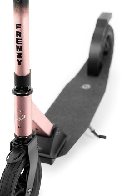 A close-up of the Frenzy 205mm Air Zero Foldable Commuter Scooter in black and rose, designed for commuting. The brand name "FRENZY" is printed on the rose-colored vertical handlebar. It includes a textured black deck, rear foot brake, and visible front and rear wheels equipped with tubeless rubber tires for a smooth ride.