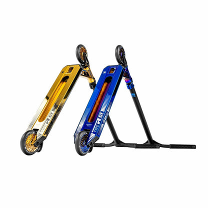 Two vibrant pro scooters are tilted for display, with one featuring the Root Industries branding in their "Gold Rush" colorway and black accents, while the other boasts a blue finish with black and white details. These lightweight scooters are showcased on their rear wheels, highlighting their elegant designs and deck graphics.