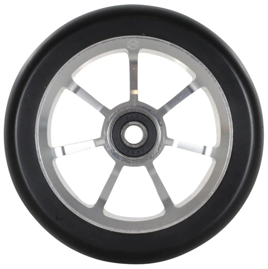 The Native Stem 110mm Stunt Scooter Wheel in Chrome Silver features a detailed close-up of its design, highlighting a black rubber outer rim paired with a metallic inner rim. The wheel is embellished with an intricate circular pattern and six evenly spaced spokes that extend from the central hub, underscoring the durability needed for performing remarkable stunts.