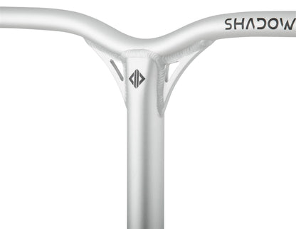 Close-up of a bicycle handlebar with a sleek, metallic finish akin to the Drone Shadow 2 Aluminium IHC Stunt Scooter Bars. The Y-bar design showcases a central beam, reinforced joints, and minimal branding at the top right and center.