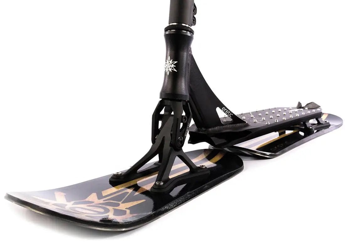 A close-up view of the Eretic Snow Scooter - Slope highlights its black frame, featuring a unique suspension system and patterned skis ideal for winter tricks. The design is enhanced by intricate golden graphics on the front ski, showcasing exceptional craftsmanship.