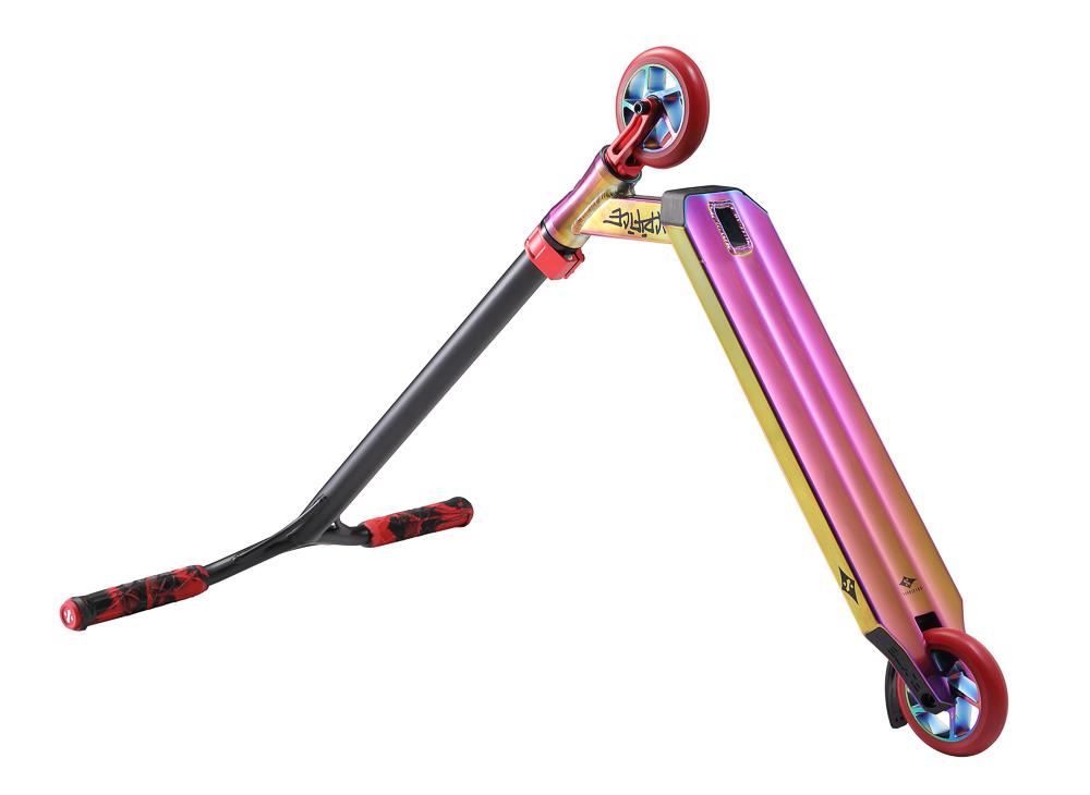 The Sacrifice Flyte 115 V2 Complete Stunt Scooter in Neochrome / Red Grafitti is a lightweight and vibrant scooter with a gradient deck featuring shades of pink, purple, and gold. It comes equipped with red and black patterned grips, striking red wheels with blue hubs, and a sleek black handlebar designed for dynamic rides.