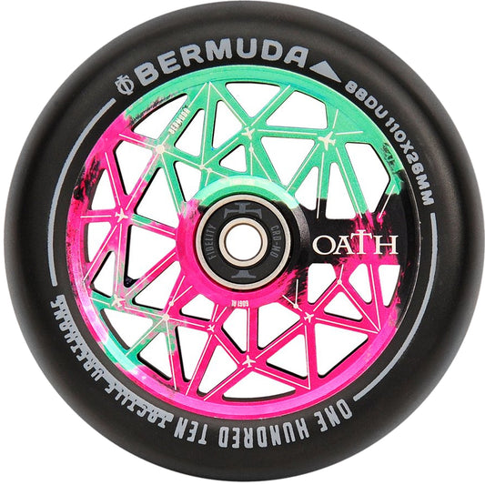 A close-up of a scooter wheel showcases its sleek black exterior, highlighted by a vibrant center featuring pink and green geometric designs. The wheel is marked with "BERMUDA" and "OATH" along with the specifications: "88DU 110x26mm." It incorporates high-grade Oath Fidelity bearings that ensure optimal corrosion resistance.