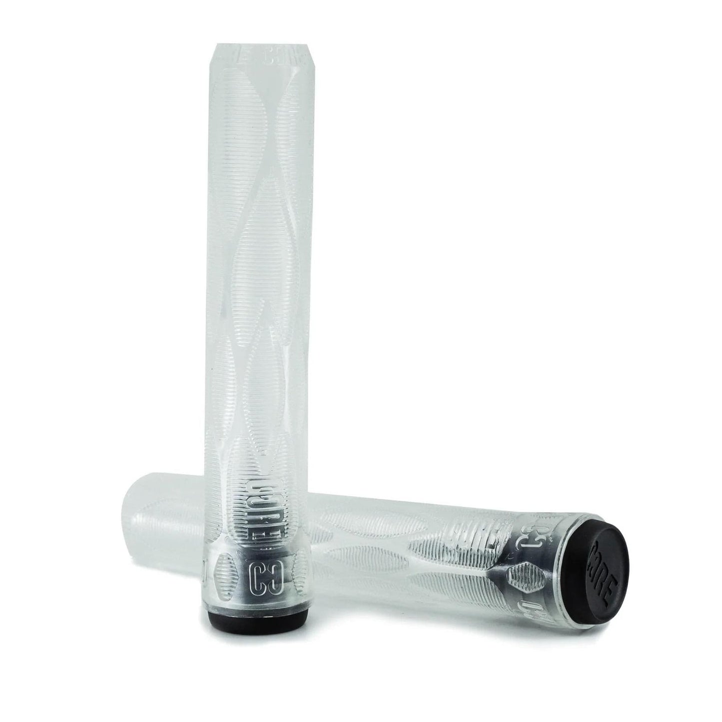 Two transparent cylindrical grips, featuring the CORE Skinny Boy Clear Stunt Scooter Grips - 170mm, are set against a white background. One grip is standing upright while the other is angled across it. The ends are black with visible logo text, emphasizing their sleek and slim design ideal for shock resistance.