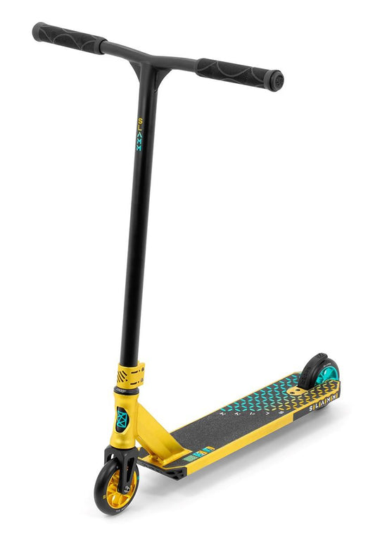 A gold stunt scooter by Slamm, the Assault Complete model, features black handlebars and an alloy deck with blue and green accents. Equipped with 110mm aluminum wheels designed for tricks, this complete scooter is displayed upright on a white background.