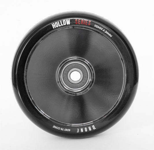 The Drone Hollow Series 110mm Stunt Scooter Wheel in Smoked Chrome features a metallic center bearing and black rim with "110MM x 24MM" and "6061 T6 Core" seen from above. Labeled "Hollow Series" and "Tronic," it's perfect for stunt scooter enthusiasts seeking high-quality design.