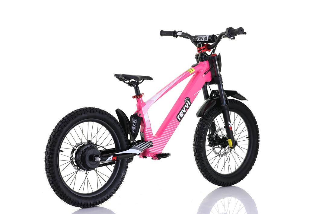 The Revvi 20" Kids Electric Balance Bike in bright pink features thick off-road tires, a black seat, handlebars, and "r3vvi" branding. With adjustable speed settings, this electric-powered motorbike showcases a modern design on a white background.