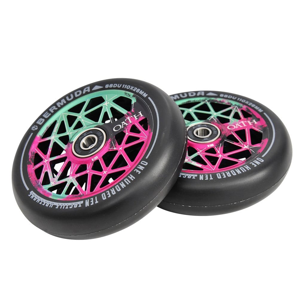 The Oath Bermuda 110mm Stunt Scooter Wheels come in vibrant pink and green geometric designs. The sleek black rims feature metallic centers, complete with Oath Fidelity bearings for smooth rides. These wheels deliver both durability and style, highlighted by text on the outer edge.