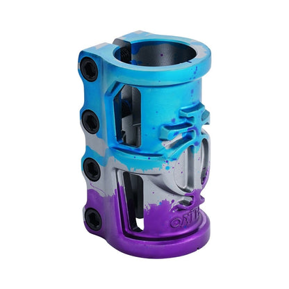 This striking Oath Cage V2 4 Bolt SCS Oversized Stunt Scooter Clamp exhibits a gradient design in blue, purple, and titanium, complete with sleek black bolts. Constructed from lightweight 6061 T6 Aluminium, it boasts a rugged industrial appearance with cut-out patterns and the iconic "Oath" logo etched on the front.