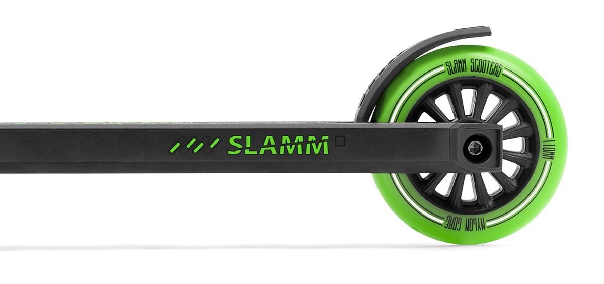 The Slamm Classic Mini Complete Stunt Scooter in green boasts a sleek black frame with stylish green text, complemented by a high-performance green wheel featuring spokes and branding details. Ideal for freestyle scootering, the design highlights the side profile of the scooter deck and wheel for a modern look.