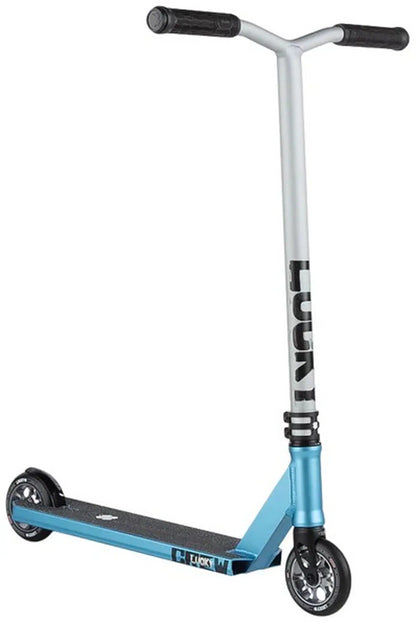 The Lucky Crew 2025 Complete Stunt Scooter - Chroma Mist is a blue and silver masterpiece with a black grip tape deck. Its T-shaped handlebar features "LUCKY" vertically on the front and has black grips. Designed for pro use, it rolls smoothly on two small, black wheels.