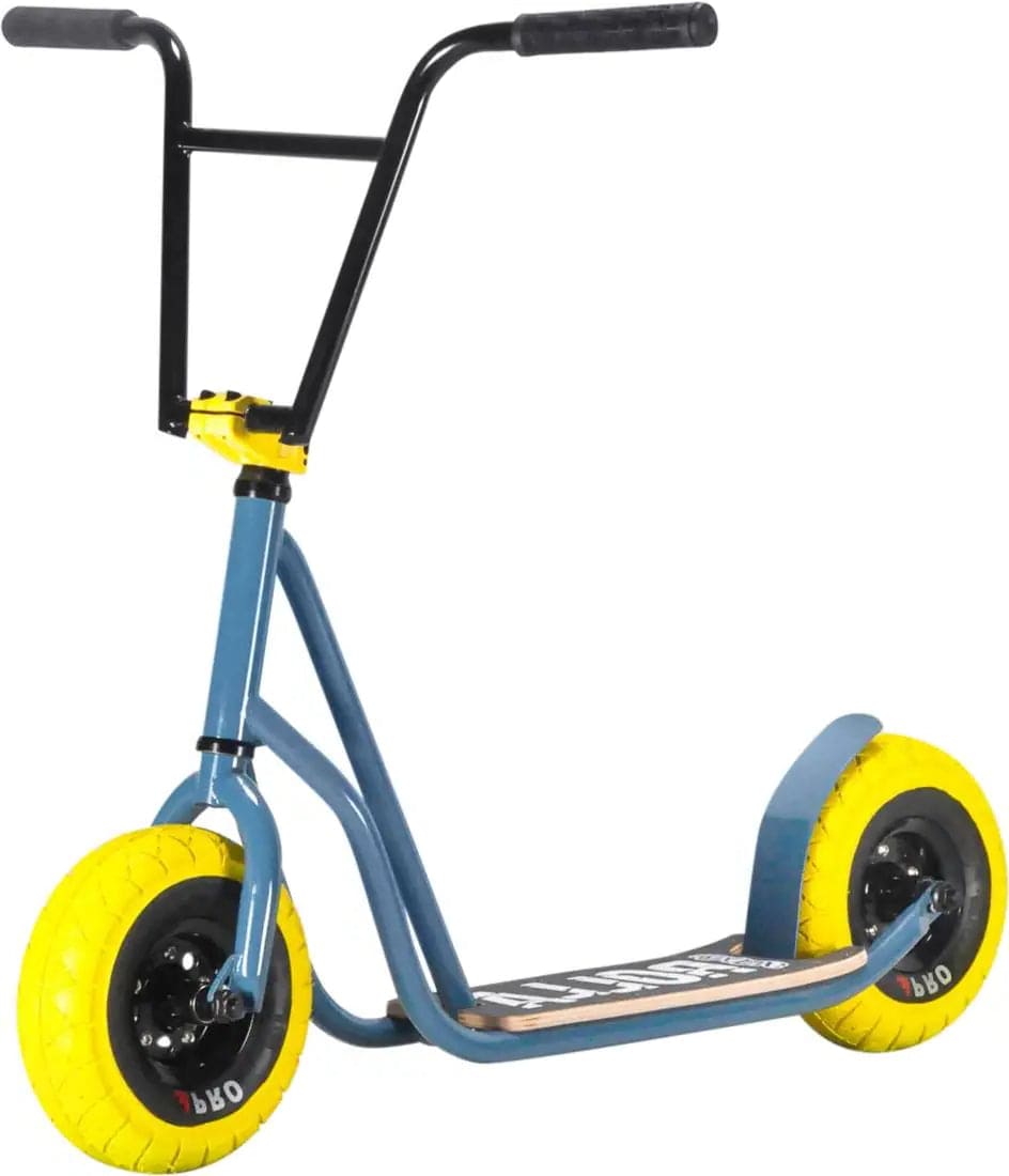 The Rocker Rolla Big Wheel Complete Scooter features a striking grey design, combined with large yellow tires and a wide handlebar, offering a mini BMX-style perfect for stunt enthusiasts.