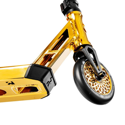 Here's an enhanced description based on the product data:

A close-up view of the Root Industries Type R GT Complete Stunt Scooter in Gold Rush showcases its gold-colored finish with a detailed wheel design. The deck features open sections and a contrasting black grip surface, while the sturdy fork supports a striking black and gold wheel, emphasizing this lightweight scooter's sleek design.