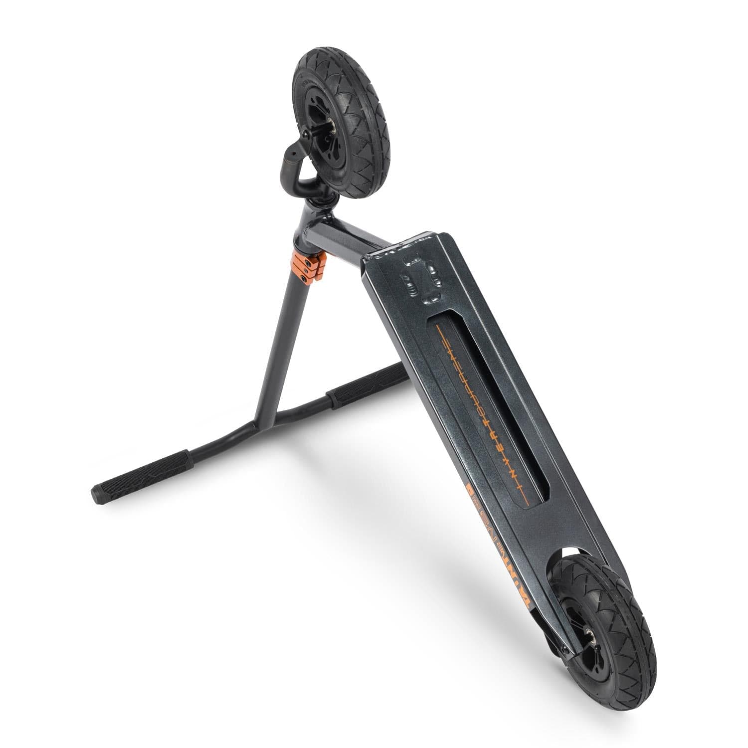 The Invert Supreme Taunt V2 Complete Dirt Scooter, in Astral Silver and Copper, is folded to display its sleek black frame and striking orange suspension, engineered for high-impact riding. One of its pneumatic wheels is grounded while the other is elevated, revealing the stand beneath. Its deck features a textured surface to enhance grip.