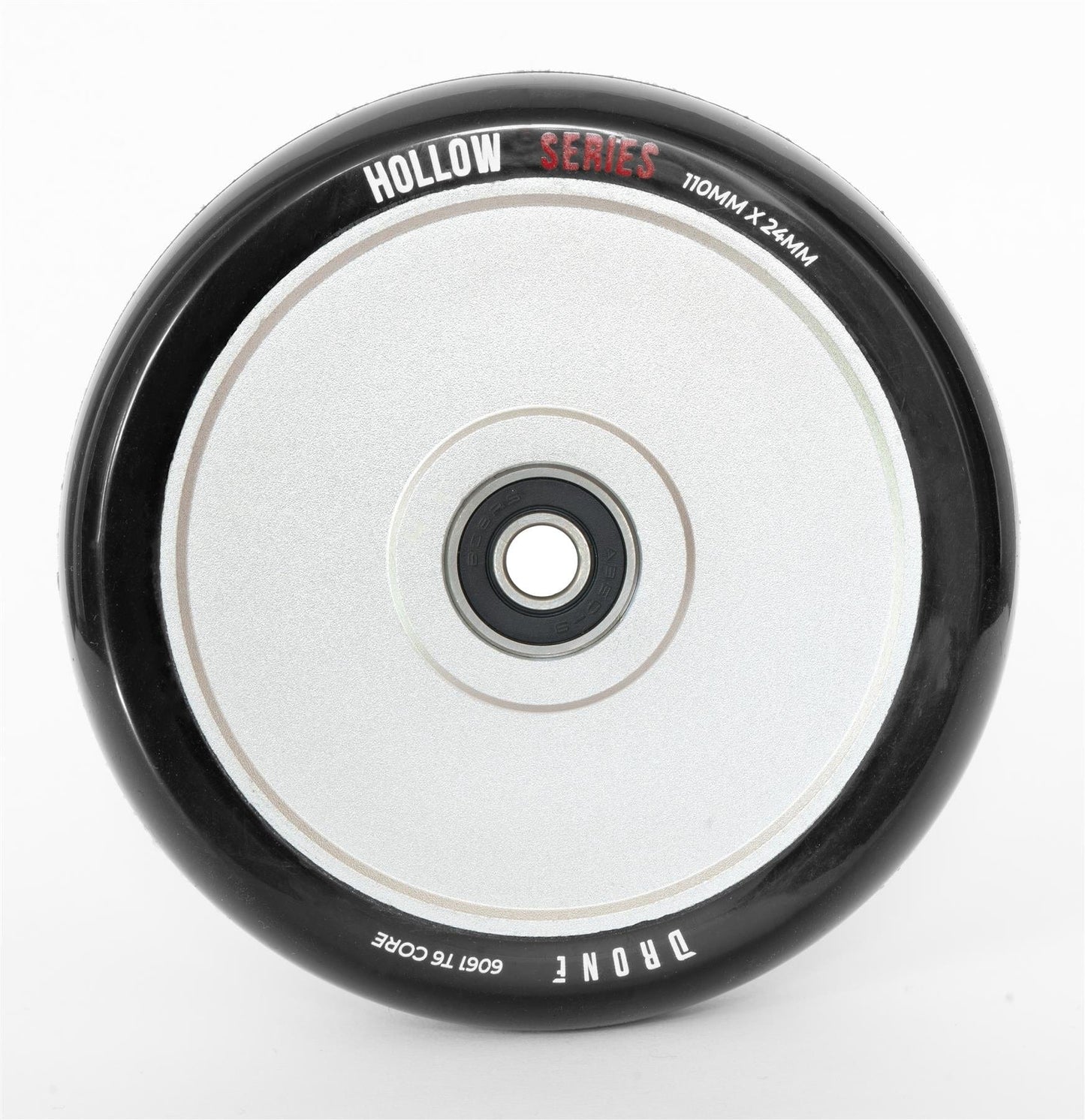 Close-up of the Drone Hollow Series 110mm Stunt Scooter Wheel - Silver, featuring its durable circular design. It has a central hub with a smooth, reflective surface, and its size (110mm x 24mm) is marked on it.