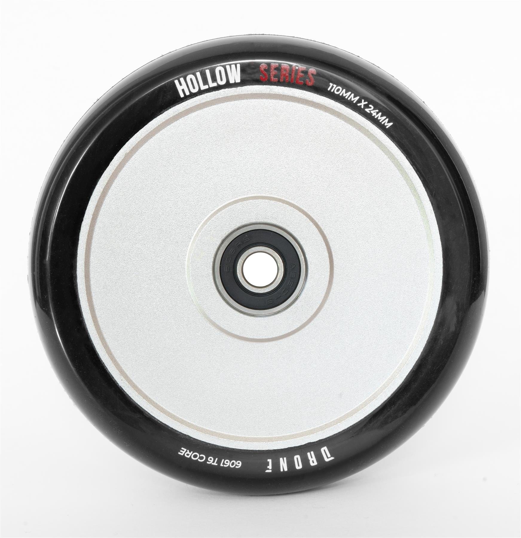 Close-up of the Drone Hollow Series 110mm Stunt Scooter Wheel - Silver, featuring its durable circular design. It has a central hub with a smooth, reflective surface, and its size (110mm x 24mm) is marked on it.