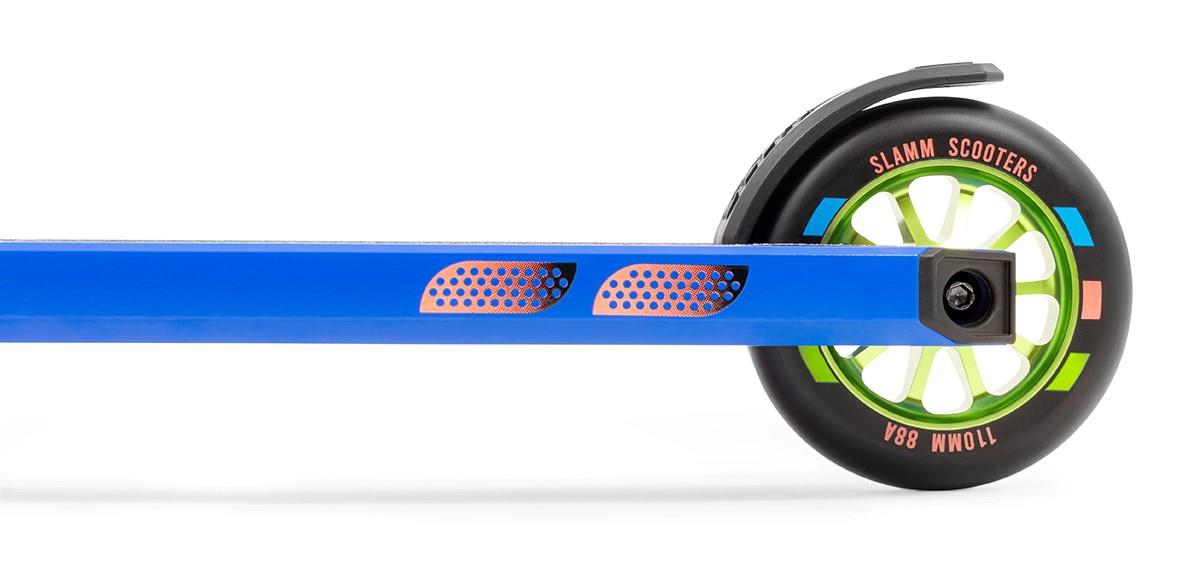 Close-up image of the Slamm Classic Complete Stunt Scooter in blue, featuring a green wheel with a black tire. The text on the tire reads "Slamm Scooters" and "110mm 88A." This scooter is equipped with 110mm alloy wheels, showcases a modern design, includes orange detailing on the frame, and offers Pro Team grips for enhanced control.