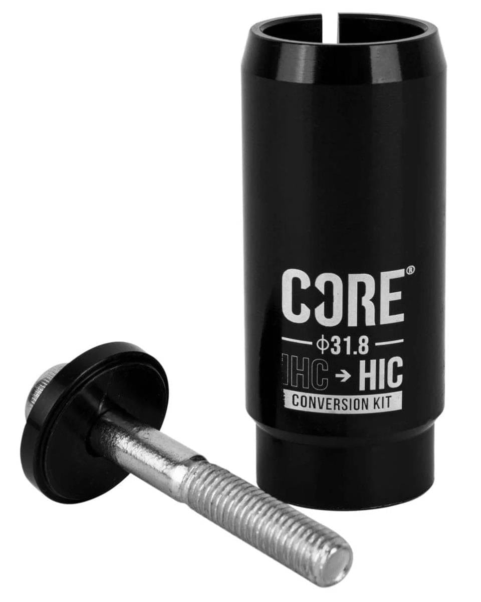 The CORE IHC To HIC Scooter Conversion Shim Kit - Black by CORE is a cylindrical black conversion kit that includes details for IHC to HIC conversions, ensuring handlebar compatibility. It is equipped with a metallic threaded bolt and a black circular end cap, making it ideal for use with IHC forks.