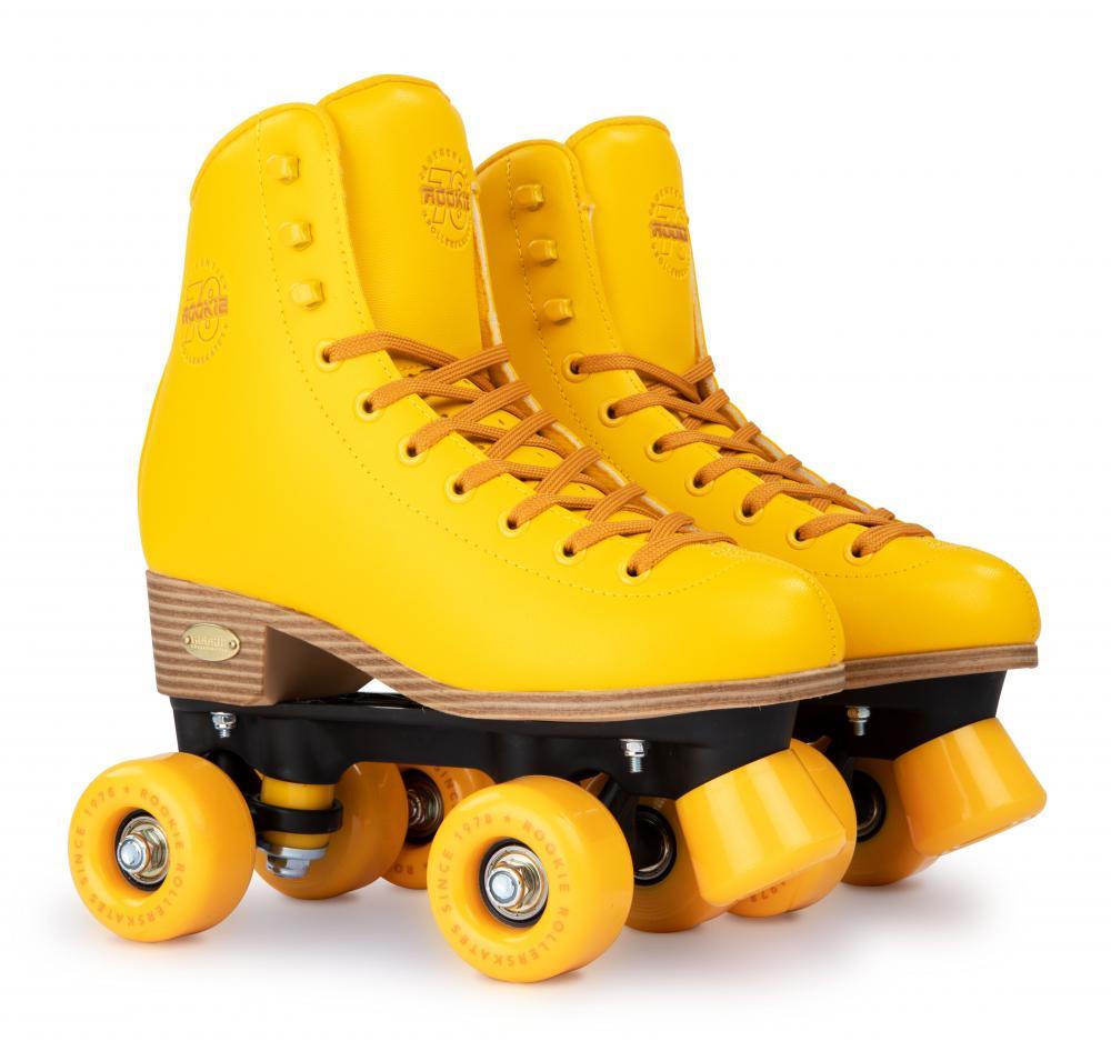 The Rookie Classic 78 Quad Roller Skates, designed by Rookie, feature a bright yellow vegan-friendly design with wooden heels and black bases. They include four matching wheels and laces, displayed upright on a white background, highlighting their timeless style.