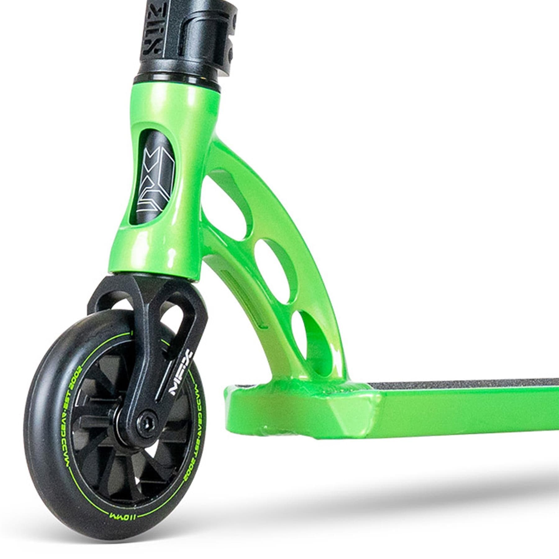 Close-up of the MGP VX Origin III 450 Complete Stunt Scooter - Dragon Skin by Madd Gear, showcasing its bright green front wheel with intricate spokes and deck with sturdy headtube featuring circular cutouts. It has ultra-light aluminum handlebars and a sleek finish.