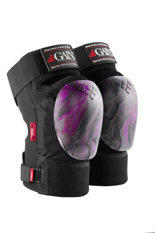 A pair of GAIN Protection The Shield Pro Knee Skate Pads in purple and black, ideal for freestyle scootering. They come with adjustable straps and feature branding labels on the top.