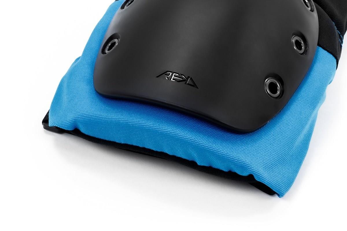 A close-up of the REKD Ramp Knee Pads in Black/Blue highlights their sleek design featuring a black protective shell with eyelets and an embossed "REKD" logo. Ideal for action sports, these knee pads provide outstanding impact resistance, set against a white background.