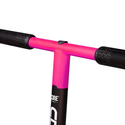 Close-up of the CORE CD1 Complete Stunt Scooter handlebar featuring black grips with a pattern for better hold. The center joint is pink and slightly textured, offering a nice contrast to the sleek black finish. Ideal for beginner riders, it complements its durable aluminum deck beautifully.