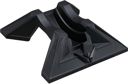 A black Blunt Envy Scooter Stand V2 showcases a futuristic design with sharp edges and geometric shapes. It features a sleek, glossy finish on the base and includes a central groove to accommodate 30mm wide wheels, with a web link printed along its edge.