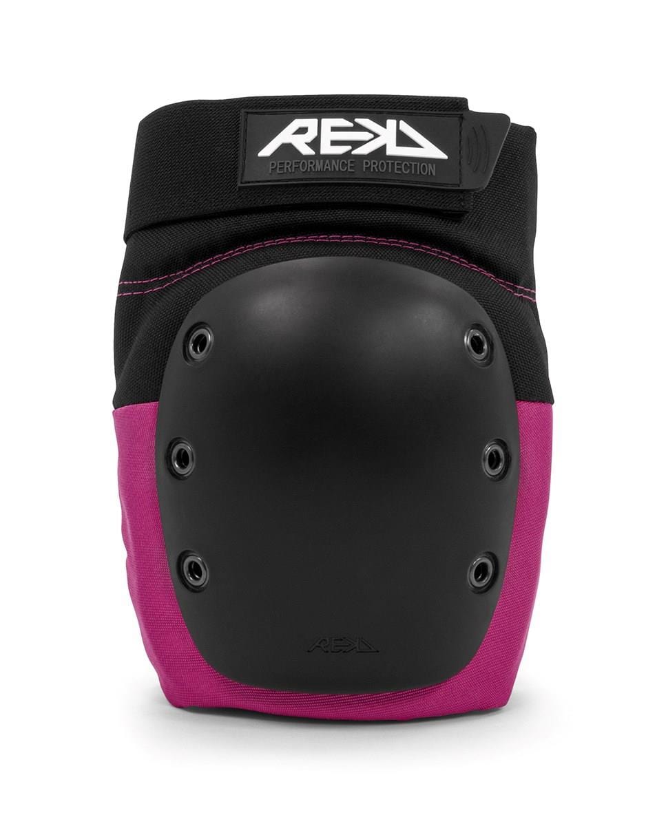 The REKD Ramp Knee Skate Protection Pads in black and pink boast a hard, rounded protective shell for excellent impact resistance. Ideal for action sports, they feature the brand name "REKD" prominently on the top strap, while ventilation rivets enhance comfort during high-intensity activities.