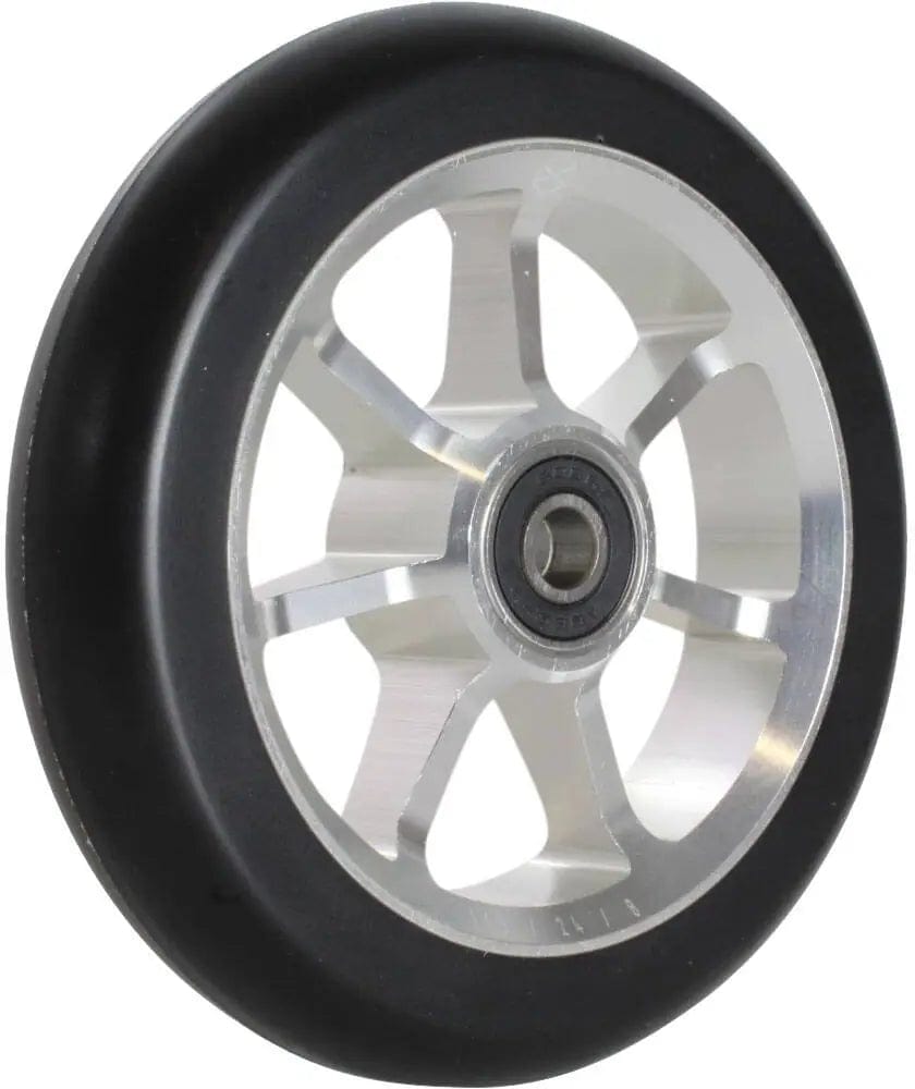 A close-up of the Native Stem 110mm Stunt Scooter Wheel - Chrome Silver reveals a black rubber tire and a silver metal core with a stylish five-spoke design. The central bearing is visible, highlighting the durability and style synonymous with the Native brand.