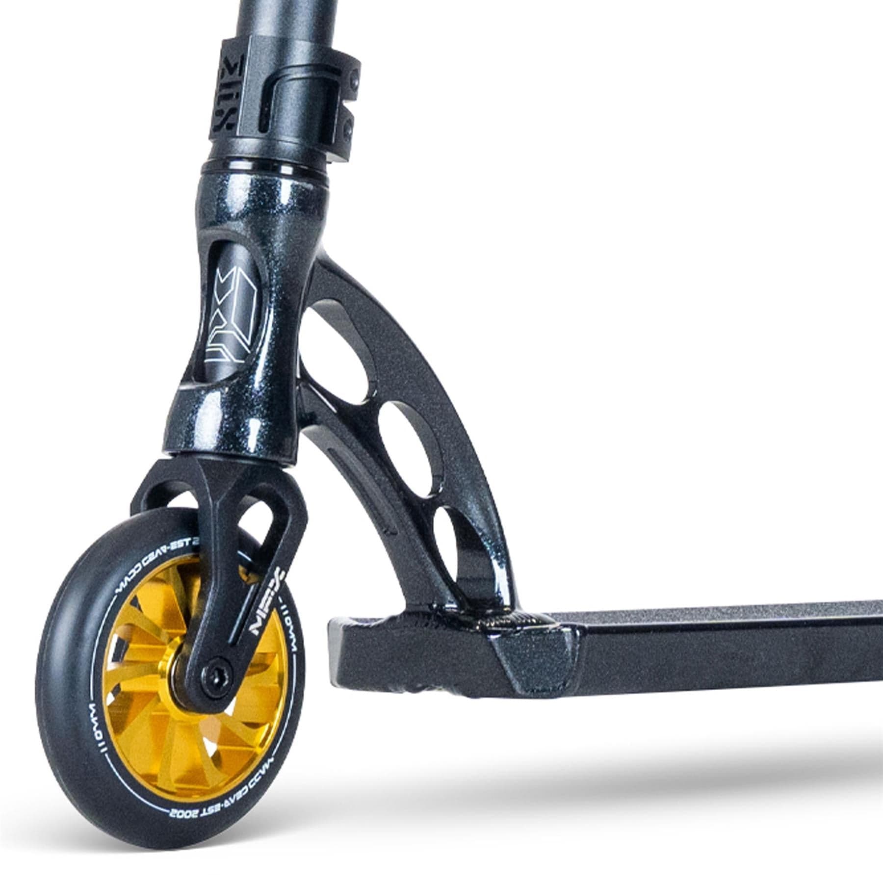 Close-up of the MGP VX Origin III 500 Complete Stunt Scooter's front wheel and deck in Diamond Black Metallic. The yellow wheel features a black tire, while the fork has a unique cut-out design. With durable aluminium handlebars, the deck and fork boast a shiny black finish.