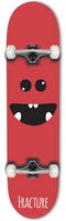 The Fracture Lil Monster Red Mini Complete Skateboard, measuring 7.25" x 28.9", showcases a cartoon face design with a big, smiling mouth and eyes. The word "Fracture" appears at the bottom of the deck. As part of the Lil Monsters series, this skateboard includes white wheels and metal trucks.