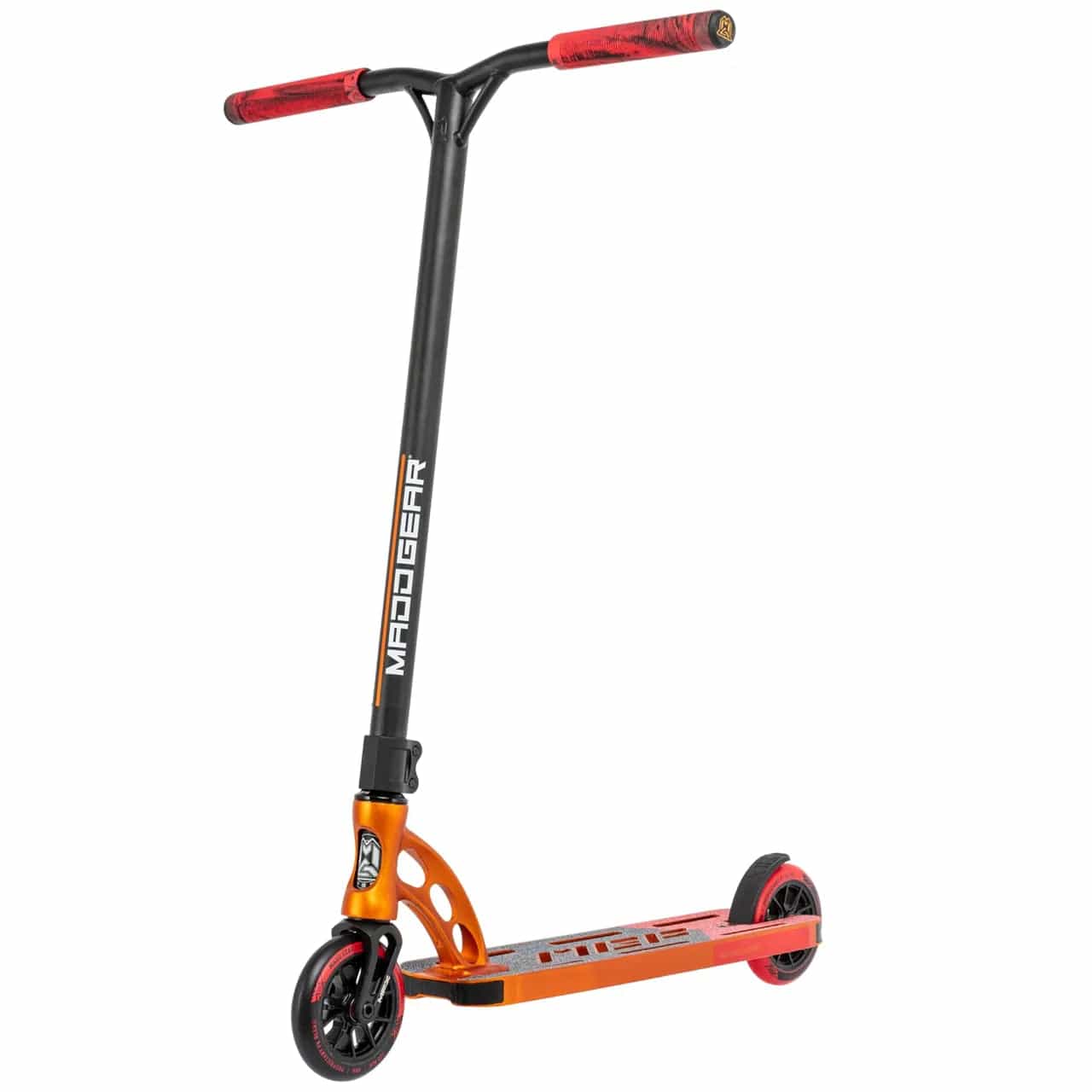 The Madd Gear MGP VX Origin Team Edition Complete Stunt Scooter - Orange / Red is a durable and lightweight scooter with a sleek design. This stunt scooter, featuring small wheels and red handle grips, prominently displays the Madd Gear (MGP) brand name on its black handlebar stem against a plain white background.