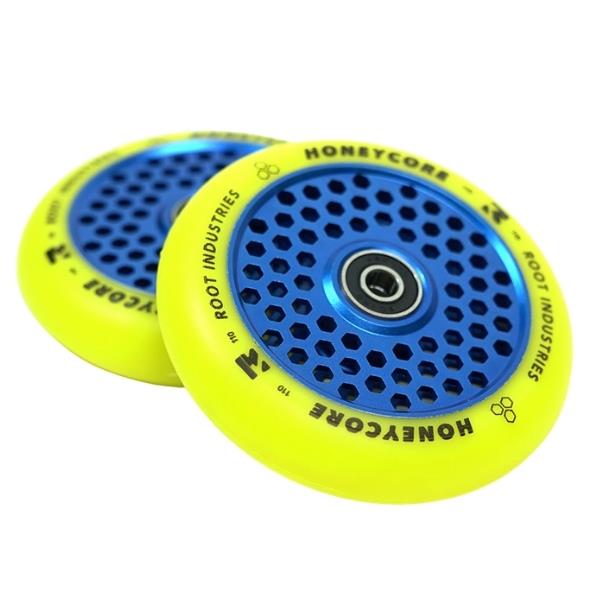 A pair of Root Industries Honeycore 110mm stunt scooter wheels in yellow, featuring a distinctive honeycomb cutout design. These wheels are equipped with ABEC 11 bearings for ultra-high rebound performance, and they feature a blue core with black text reading "Honeycore" and "Root Industries" along the edges for enhanced style and smooth riding.