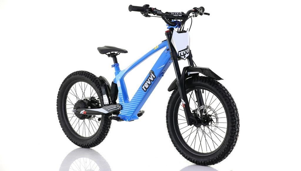 The Revvi 20" Kids Electric Balance Bike in blue, displayed on a white background, showcases durable off-road rubber tires, a black seat and handlebars, and a front white number plate. The brand "Revvi" is prominently etched on its frame.