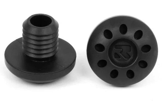 Two black cylindrical objects, one positioned horizontally and the other vertically, are made from durable materials. The top surfaces display a pattern of circular holes surrounding a central logo, similar to the Root Industries Fractal Standard Scooter Bar Ends in black. A threaded section can be seen in the side view.