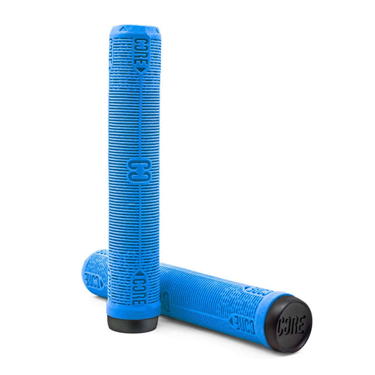 Close-up of two blue handlebar grips from CORE, designed for universal use on scooters and bikes. These grips, featuring a "CORE" embossing, incorporate a ribbed pattern for shock resistance and are capped in black. The CORE Skinny Boy Dark Blue Stunt Scooter Grip stands upright while another lies horizontally.