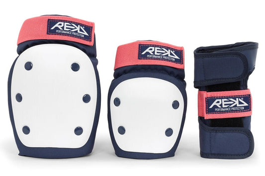 The REKD Heavy Duty Triple Skate Protection Pad Set in blue and pink includes impact-protective knee pads with white and navy blue padding highlighted by pink accents, as well as navy blue wrist guards accented with a pink strap. Each component is emblazoned with the "REKD Performance Protection" logo.