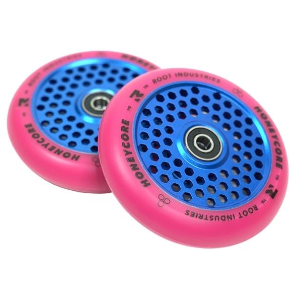 The Root Industries Honeycore 110mm stunt scooter wheel showcases a vibrant design with a honeycomb pattern, featuring a blue core and pink outer rim. Equipped with ABEC 11 bearings for optimal performance, the words "Root Industries" and "Honeycore" are printed on the rims.