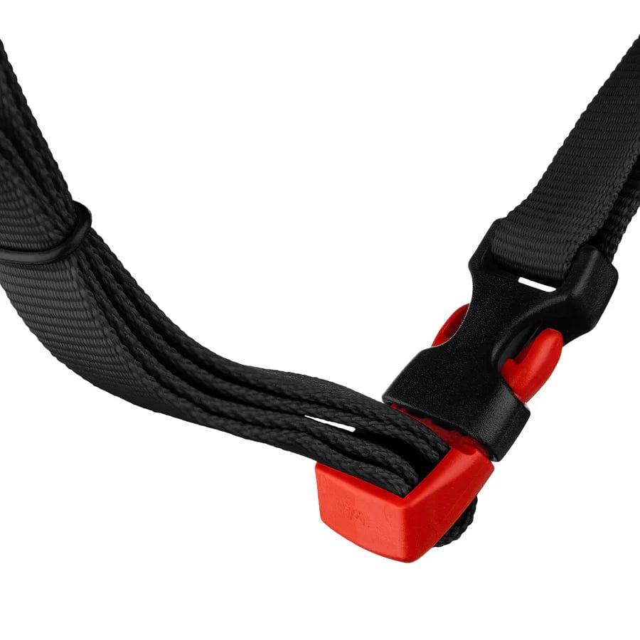 A close-up of a black plastic buckle featuring a red release button, attached to a black woven strap, similar to those used on the CORE Action Sports Skate / Scooter Helmet by the brand CORE, isolated on a white background.