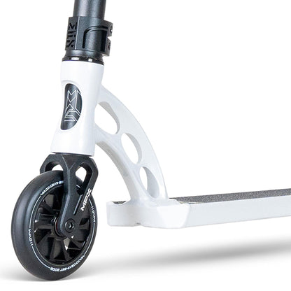 Close-up of the white stunt scooter's front wheel and deck. The MGP VX Origin III 500 by Madd Gear features a sturdy wheel design, sleek deck with textured grip, aluminum handlebars for style, and cut-out frame details for flair and reduced weight.